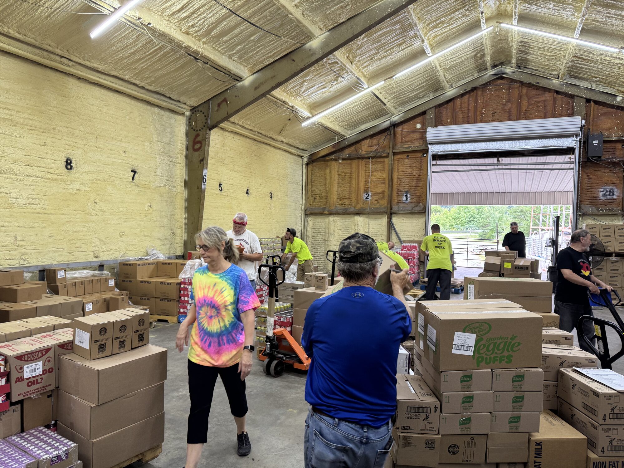 A team of volunteers works together sorting non-fat milk, snacks, and beverages into boxes to be delivered to families across Eastern Kentucky.
