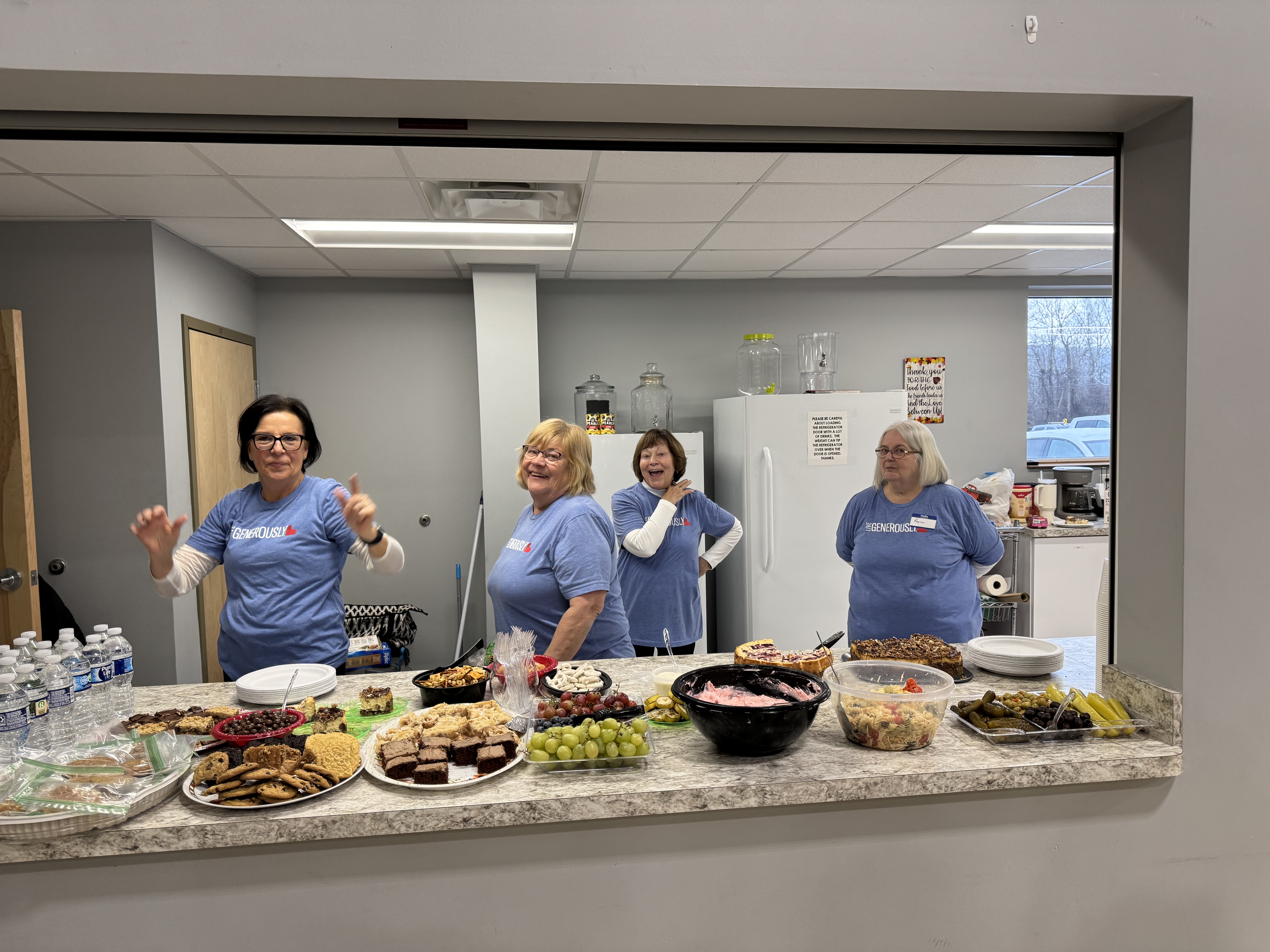 Our dedicated Servants of our Lord volunteers are all smiles, ready to welcome and nourish with a table full of delicious treats. We're so grateful for these helping hands who generously share their time and love!